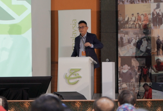 Takaful Malaysia Town Hall 2025 — speaker at podium